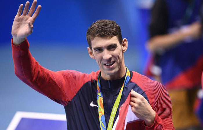 Michael Phelps of the US waves after the podium ceremony of the men’s 4x100m medley relay at the Rio 2016 Olympic Games Saturday. — AFP