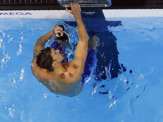 Michael Phelps reacts after finishing second