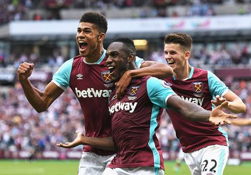 LONDON ENGLAND- AUGUST 21 Michail Antonio of West Ham United celebrates scoring the opening goal with team mates Ashley Fletcher and Sam Byram during the Premier League match between West Ham United and AFC Bournemouth at London Stadium on Augu