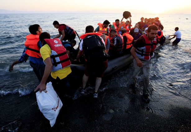 Migrants and refugees arrive in a rubber dinghy