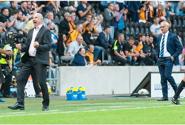 Mike Phelan celebrates Hull City's win over Leicester as Claudio Ranieri looks