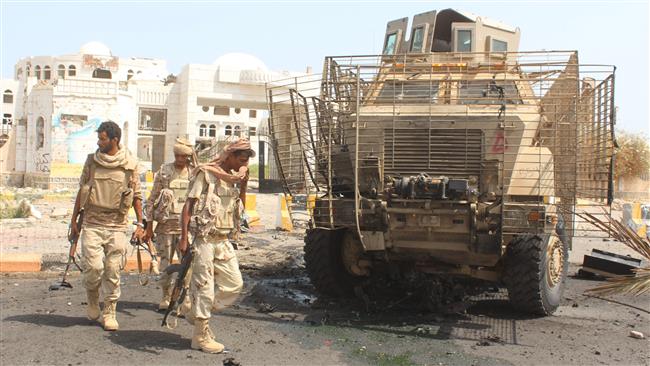 Militants loyal to Yemen’s former regime walk in Zinjibar the capital of the southern province of Abyan