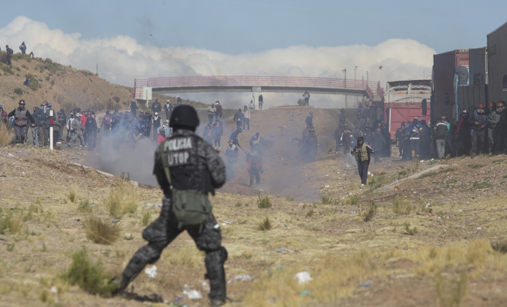 Miners clash with the police as they run from clouds of tear gas during protests in Panduro Bolivia Juan Karita  Associated Press