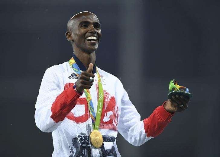 2016 Rio Olympics- Athletics- Victory Ceremony- Men's 5000m Victory Ceremony- Olympic Stadium- Rio de Janeiro Brazil- 20/08/2016. Gold medalist Mo Farah of Britain celebrates on the podium. REUTERS  Dylan Martinez