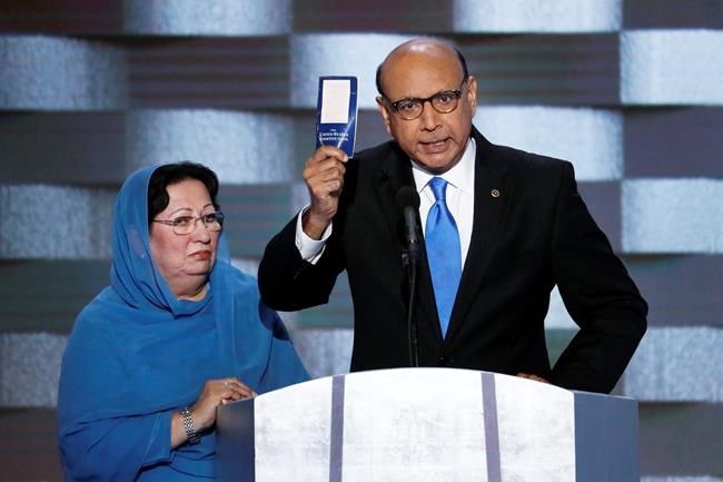 Khizr Khan father of fallen US Army Capt. Humayun S. M. Khan holds up a copy of the Constitution of the United States as his wife listens during the final day of the Democratic National Convention in Philadelphia