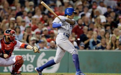 Kansas City Royals&#039 Raul Mondesi right hits a three-run triple as Boston Red Sox's catcher Sandy Leon left looks on in the sixth inning of a baseball game Sunday Aug. 28 2016 in Boston