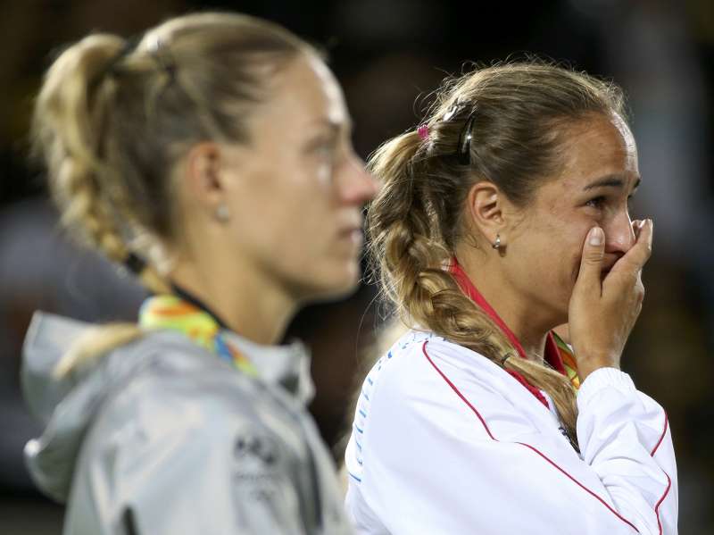 2016 Rio Olympics- Tennis- Victory Ceremony- Women's Singles Victory Ceremony- Olympic Tennis Centre- Rio de Janeiro Brazil- 13/08/2016. Gold medalist Monica Puig of Puerto Rico and silver medalist Angelique Kerber of Germany react afte