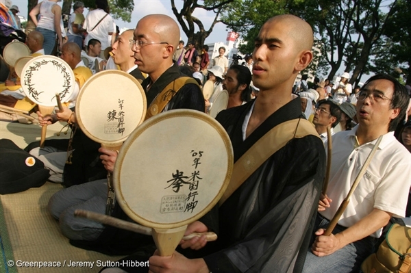 Monks pray beside the A Bomb Dome Memorial during the 60th Anniversary of the Hiroshima Atomic Bombing in 2005