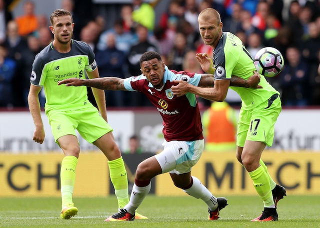 Burnley's Andre Gray in action with Liverpool's Ragnar Klavan and Jordan Henderson. Reuters