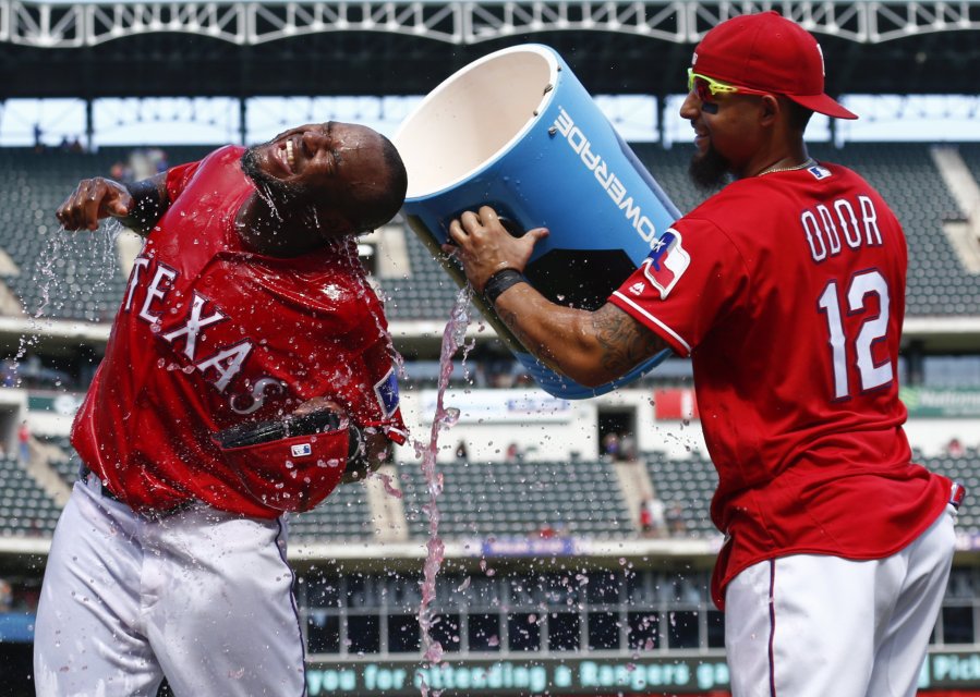 Texas Rangers&apos Hanser Alberto left reacts after getting doused by Rougned Odor following their team's 5-3 win over the Kansas City Royals in a baseball game Sunday