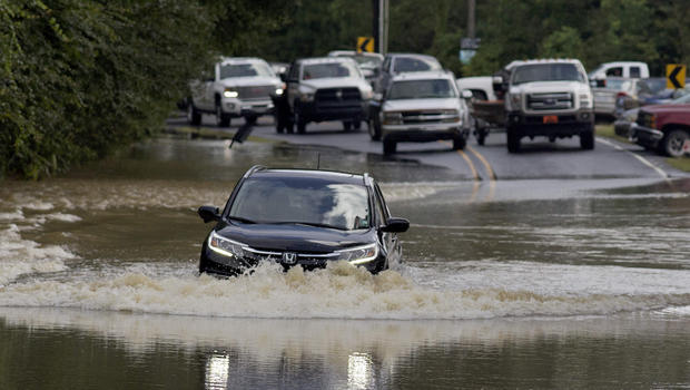 Motorists try to navigate deep water flowing over a road in Walker La. Monday Aug. 15 2016. AP