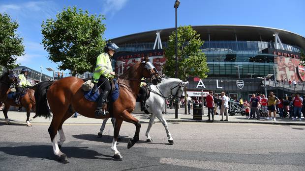 Mounted police make their way past the Emirates Stadium