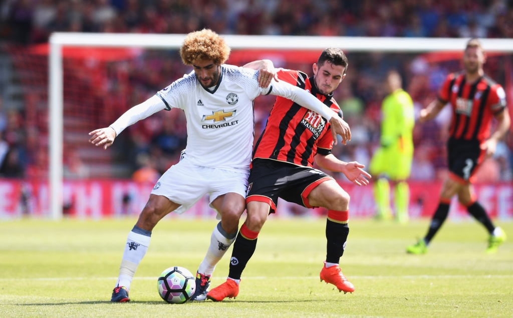 BOURNEMOUTH ENGLAND- AUGUST 14 Marouane Fellaini of Manchester United is challenged by Lewis Cook of AFC Bournemouth during the Premier League match between AFC Bournemouth and Manchester United at Vitality Stadium