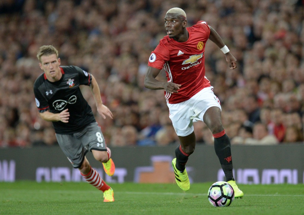 Manchester United's French midfielder Paul Pogba runs with the ball during the English Premier League football match between Manchester United and Southampton at Old Trafford in Manchester north west England