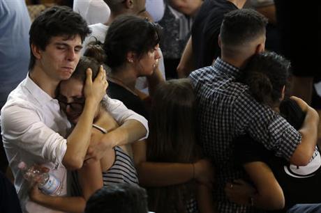 Relatives and friends mourn during the state funeral service of some of the earthquake victims in Ascoli Piceno Italy Saturday Aug. 27 2016. Funerals for some victims took place on Friday while those for many others are expected in the coming days