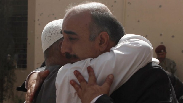 Friends and relatives of victims grieve at the scene of a bomb blast