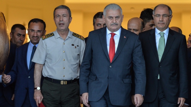 Turkey's Prime Minister Binali Yildirim centre right Chief of Staff Gen. Hulusi Akar centre left Justice Minister Bekir Bozdag left and Interior Minister Efkan Ala arrive for a press conference in Ankara Turkey Saturday