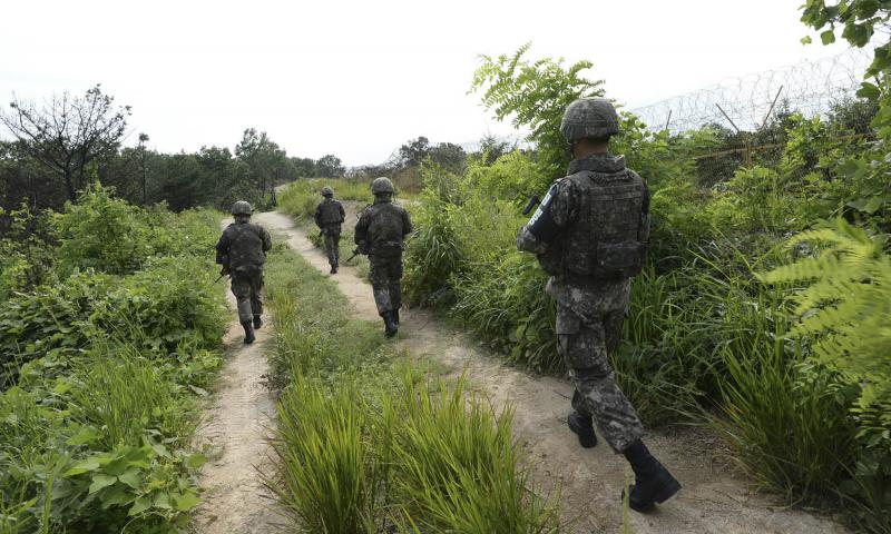 South Korean soldiers patrol inside the Demilitarized Zone near Paju South Korea in August 2015 after explosions from land mines laid by North Korea maimed two South Korean soldiers. South Korea’s military said it conducted its largest-ever artillery