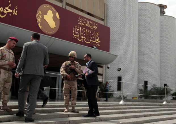 Iraqi security forces stand guard outside the parliament in Baghdad