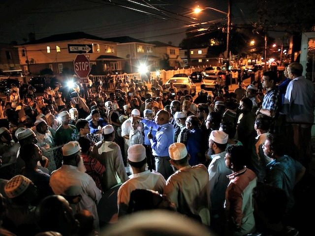 Community members pray outside the Al Furqan Jame Mosque in Ozone Park after imam Maulama Akonjee and friend Thara Uddin were killed in the Queens borough of New York City