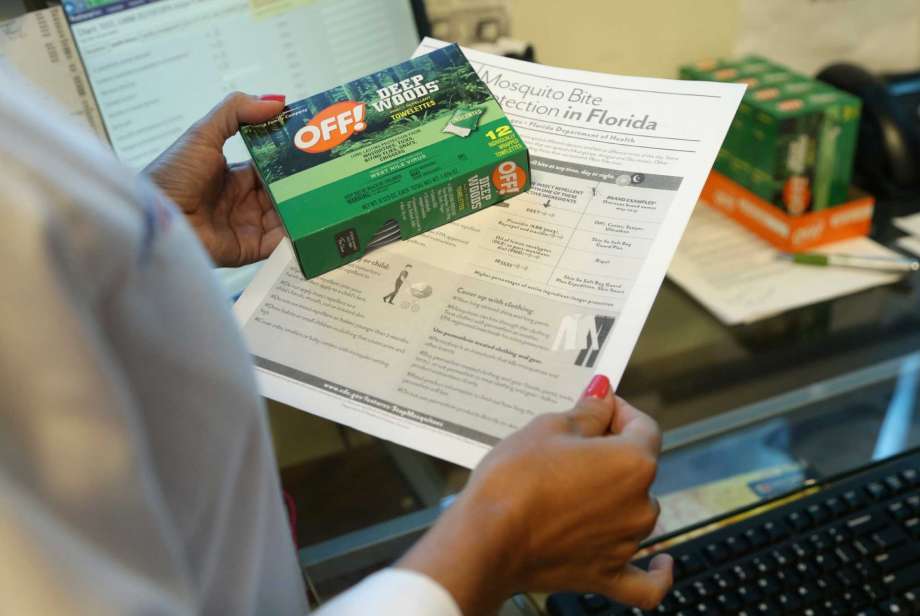 Nurse practitioner Juliana Duque holds a box of insect repellent and information on mosquito protection that she gives her pregnant patients at the Borinquen Medical Center Tuesday Aug. 2 2016 in Miami. The CDC has advised pregnant women to avoid trave