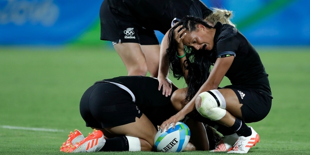 New Zealand's Tyla Nathan-Wong right and her teammates are overcome with emotion after losing the women's sevens final