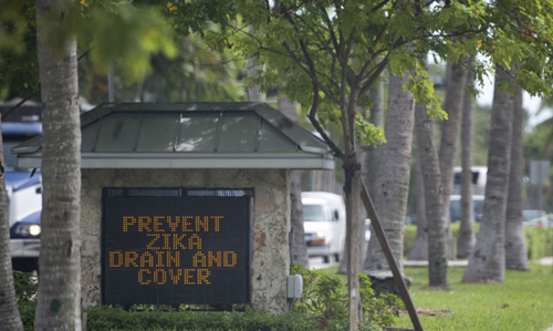 A sign at the entrance of one Florida town reminds residents to drain or cover standing water to prevent mosquitoes from reproducing in Key Biscayne Florida on Aug. 17 2016. /AP