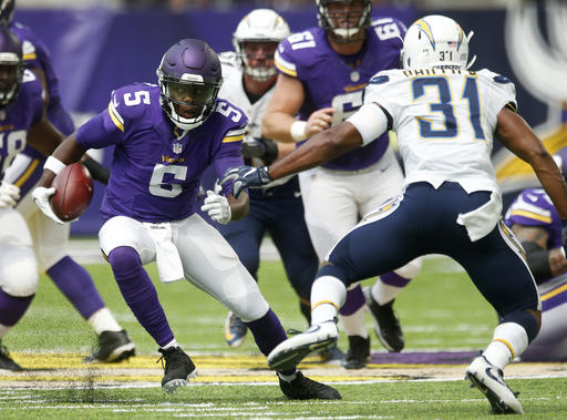 Minnesota Vikings quarterback Teddy Bridgewater scrambles upfield ahead of San Diego Chargers cornerback Adrian Phillips during the first half of an NFL preseason football game Sunday Aug. 28 2016 in Minneapolis