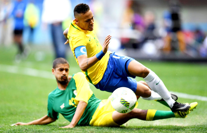 Brazil’s Neymar is tackled by South Africa’s Lebo Mothiba during their 2016 Olympic football match at the Mane Garrincha Stadium in Brasilia Thursday. — AFP