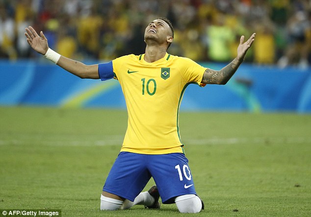 Neymar drops to his knees in celebration after scoring the winning penalty for gold in Rio