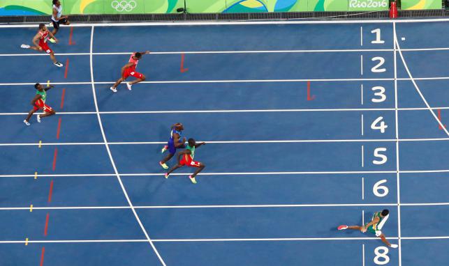 Wayde van Niekerk of South Africa runs towards the finish line