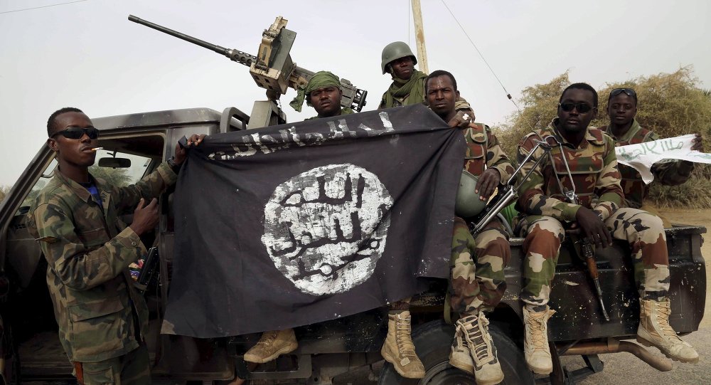 Nigerien soldiers hold up a Boko Haram flag that they had seized in the recently retaken town of Damasak Nigeria