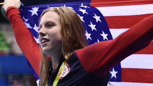 USA's Lilly King waves her national flag on the podium after she won the Women's 100m Breaststroke Final during the swimming event at the Rio 2016 Olympic Games at the Olympic Aquatics Stadium in Rio de Janeiro