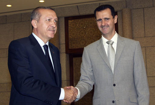 Syrian President Bashar Assad right shakes hands with Turkish Prime Minister Recep Tayyip Erdogan left at al Shaab presidential palace in Damascus Syria. Within minu