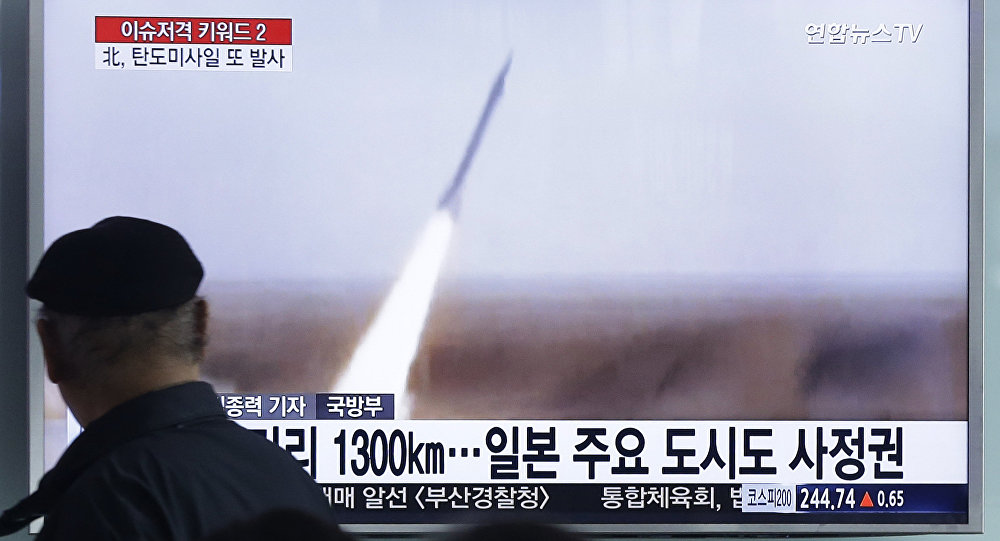 A man watches a TV screen showing a file footage of the missile launch conducted by North Korea at Seoul Railway Station in Seoul South Korea Friday