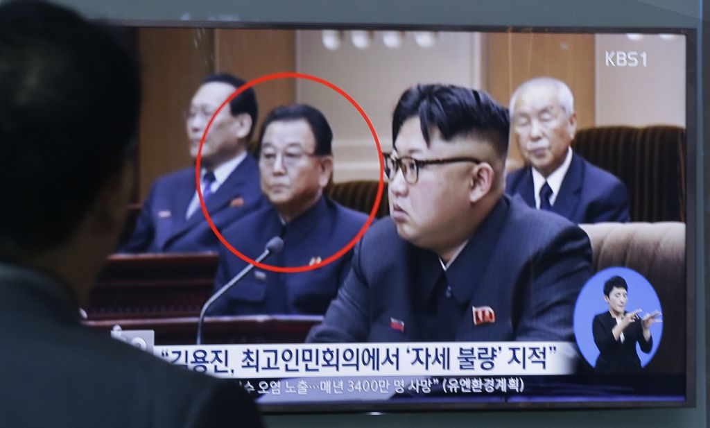 A man watches a TV screen showing Kim Yong Jin second from left a vice premier on education affairs in North Korea's cabinet and North Korean leader Kim Jong Un second from right Wednesday Aug. 31 2016