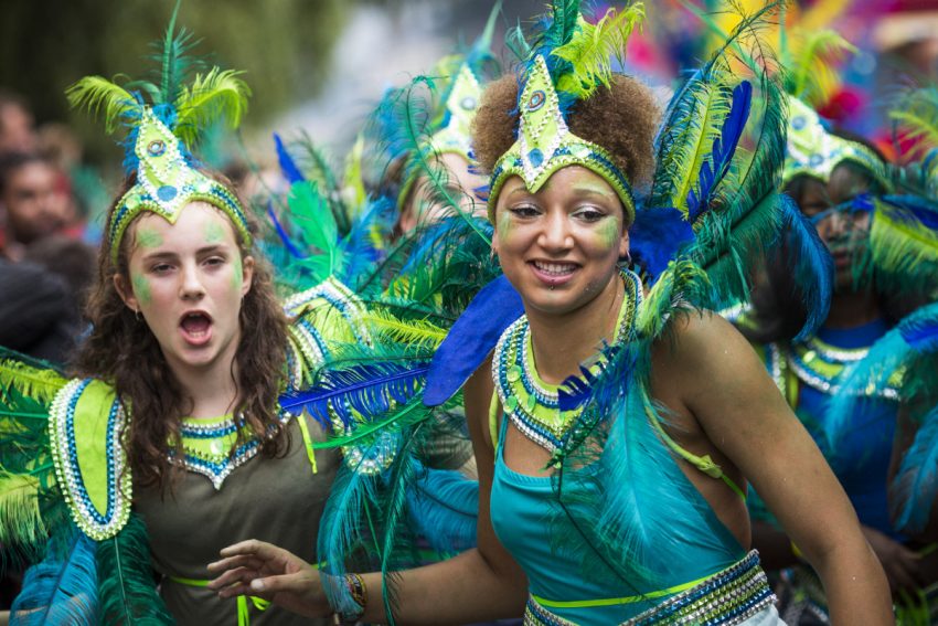 The two-day event started by members of the Afro Caribbean community sees costumed performers take to the streets in a parade and dozens of sound systems set up around the Notting Hill streets