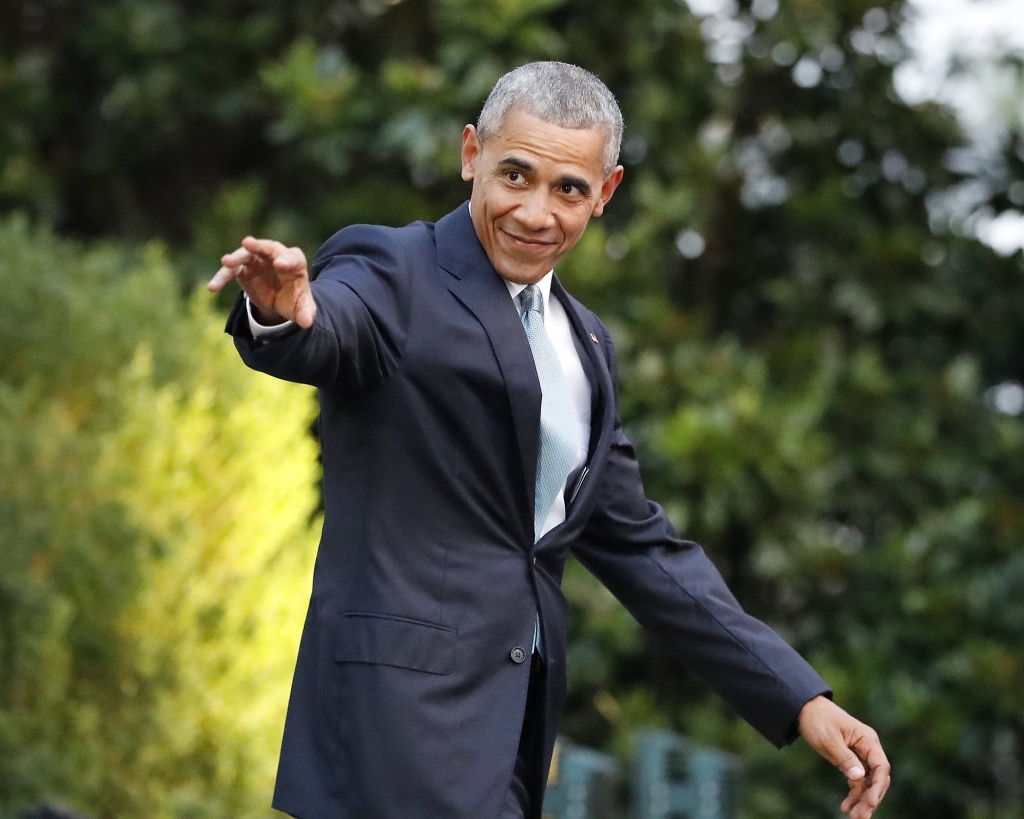 President Barack Obama waves as he walks out to the South Lawn of the White House in Washington before boarding Marine One helicopter for the short flight to nearby Andrews Air Force Base. Obama is tout