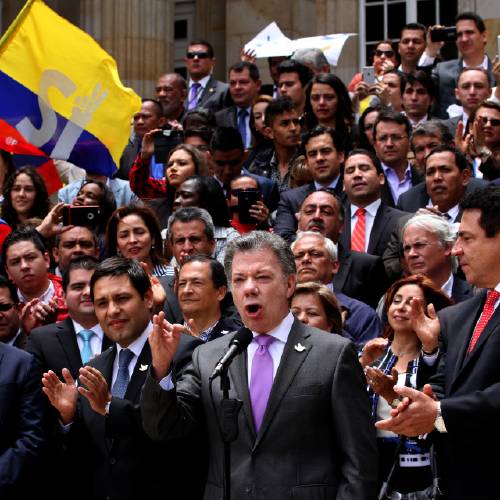 Juan Manuel Santos front second from right speaks after delivering to Congress the peace deal with rebels of the Revolutionary Armed Forces of Colombia FARC in Bogota Colombia Thursday Aug. 25 2016. Santos is mov