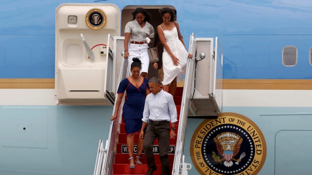 US President Barack Obama and his family leave Air Force One on the way to their annual summer vacation at Martha's Vineyard