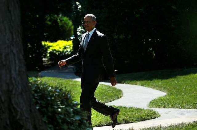 US President Barack Obama walks from the Oval Office of the White House in Washington US before his departure to the Walter Reed National Military Medical Center