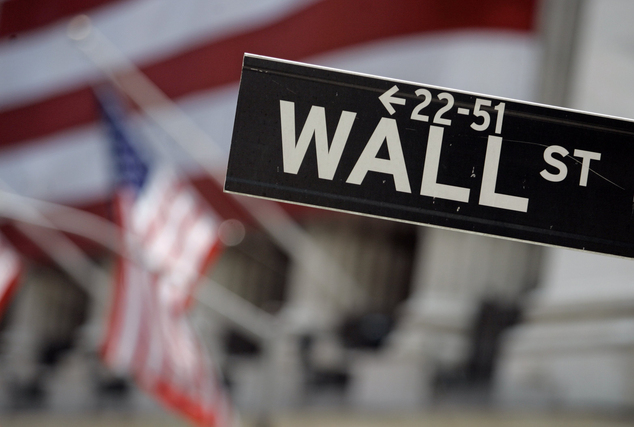 Street sign near the flag-draped facade of the New York Stock Exchange. Global stocks mostly fell Wednesd