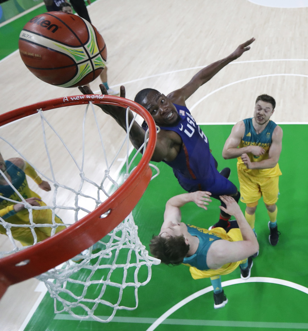 United States Kevin Durant center shoots over Australia's Cameron Bairstow left and Matthew Dellavedova right during a basketball game at the 2016 Sum