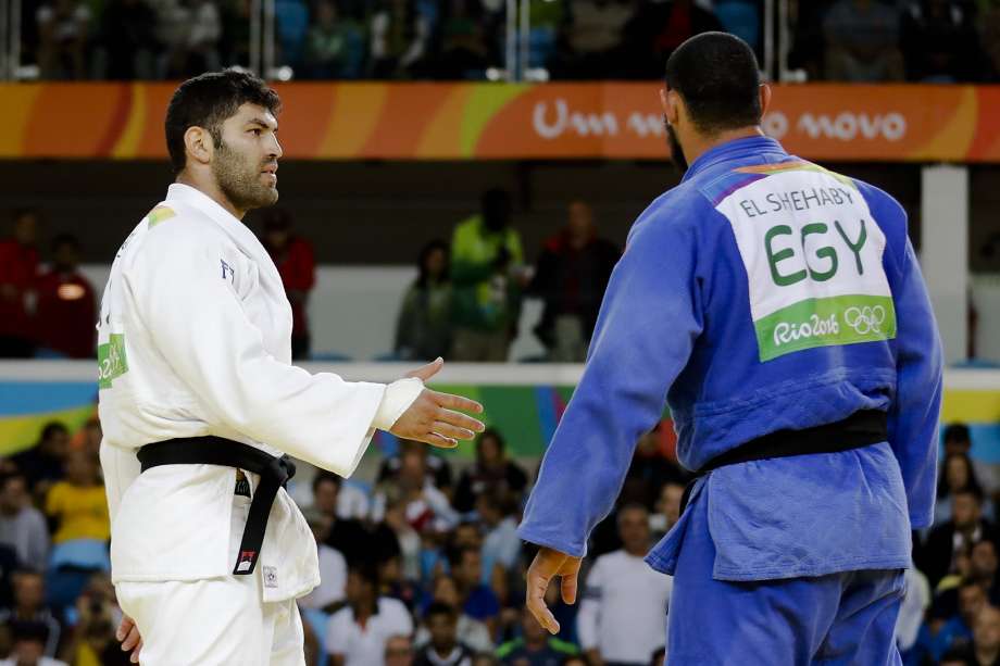 Egypt’s Islam El Shehaby right refuses to shake hands with Israel’s Or Sasson after being defeated in their over judo match. Sasson who won a bronze medal said the move wasn’t a complete surprise