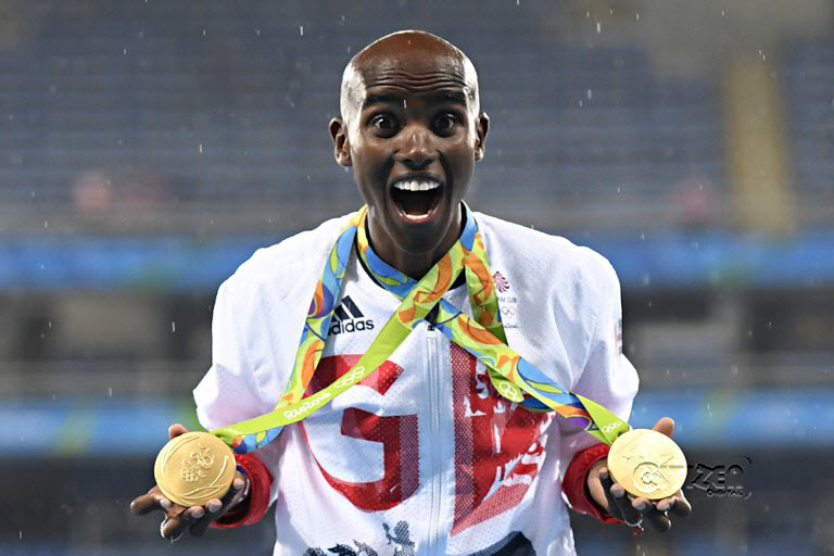 Gold medallist Britain's Mo Farah celebrates near the podium for the Men's 5000m during the