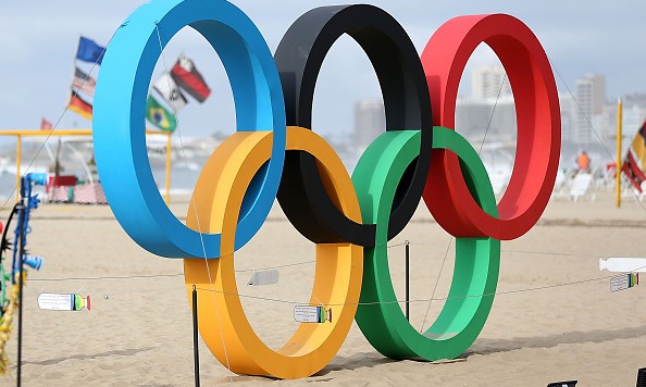 RIO DE JANEIRO BRAZIL- JULY 31 People walk by the Olympic Rings on Copacabana Beach