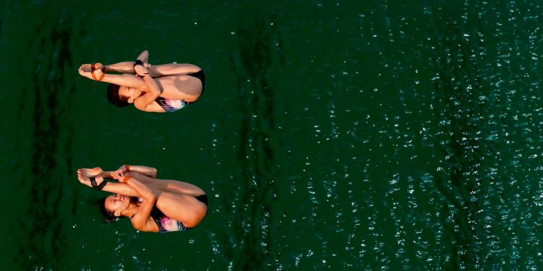 Olympic bronze medallists Roseline Filion and Meaghan Benfeito dive into the green waters of the pool at the Rio Olympics