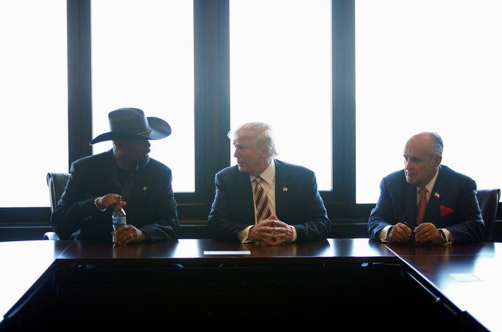 Republican U.S. presidential nominee Donald Trump talks with Milwaukee County Sheriff David Clarke Jr. and former New York mayor Rudy Giuliani at the Milwaukee County War Memorial Center in Milwaukee Wisconsin