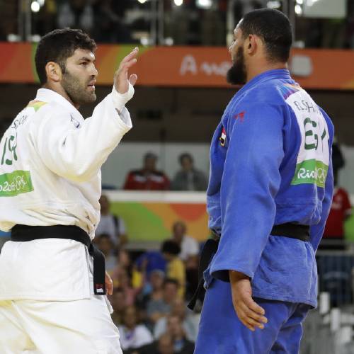 El Shehaby blue declines to shake hands with Israel's Or Sasson white after losing during the men's over 100-kg judo competition at the 2016 Summer Olympics in Rio de Janeiro Brazil Friday Aug. 12 2016. (AP Pho