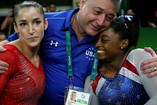 United States&#39 Simone Biles right and Aly Raisman embrace coach Mihai Brestyan after winning gold and silver respectively for the artistic gymnastics women's individual all-around final at the 2016 Summer Olympics in Rio de Janeiro Brazil Thur